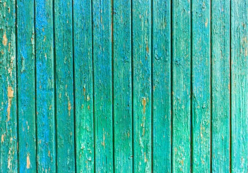 Bright green wooden background with peeling paint and vertical boards