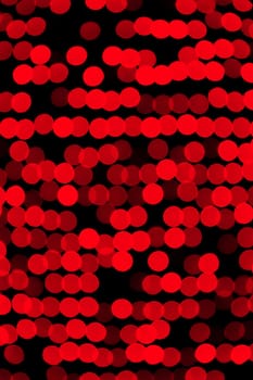 Unfocused abstract red bokeh on black background. defocused and blurred many round light.