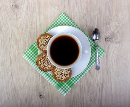 Cup of coffee wiyh pile of various shortbread and oat cookies with cereals on wooden background. Top view.