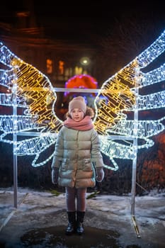 girl on the background of luminous wings evening time