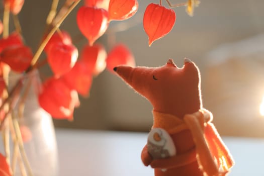 cozy autumn composition with a funny handmade toy fox, fall home decoration