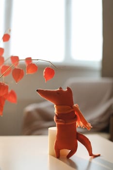 cozy autumn composition with a funny handmade toy fox, fall home decoration