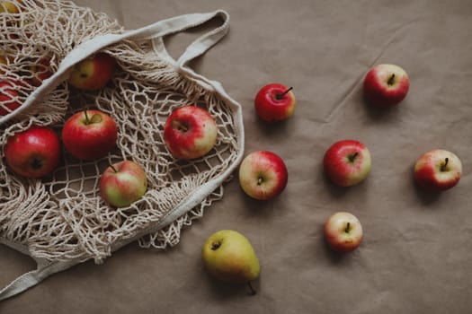 Fresh ripe red apples in a eco mesh shopping bag