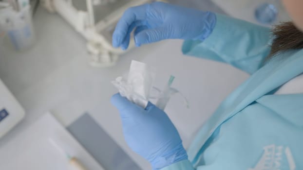 The concept of treatment.Action.A young nurse opens a new syringe and inserts a needle into it to give injections and vaccinations. High quality 4k footage