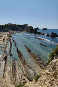 Broken coast at Liencres Cantabria , on a sunny summer day, low tide. Empty beach, low tide, clear sky, aerial view