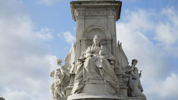 Victoria Memorial At Buckingham Palace on blue cloud background. Action. Queen Victoria Memorial in front of Buckingham Palace at London, England.