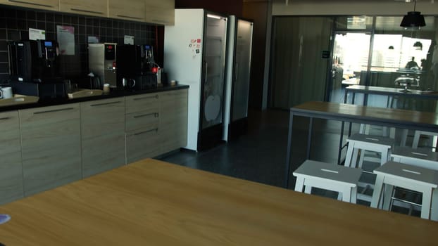 An empty kitchen. Action. Space for cooking and tables with stools in front of mirrors and refrigerators. High quality 4k footage