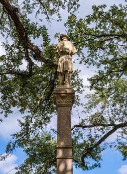 Rear view of controversial statue and monument to surrendering conferederate soldier in a park in Natchez, Mississippi