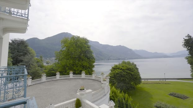 Beautiful view from the hotel balcony to the lake and lawn. Action. Warm summer day on vacation in Europe.