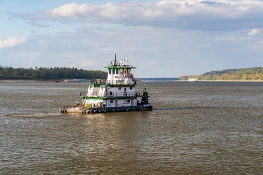 Natchez, MS - 26 October 2023: Tug Boat Jean Marie sails towards incoming steam paddleship on Mississippi by Natchez