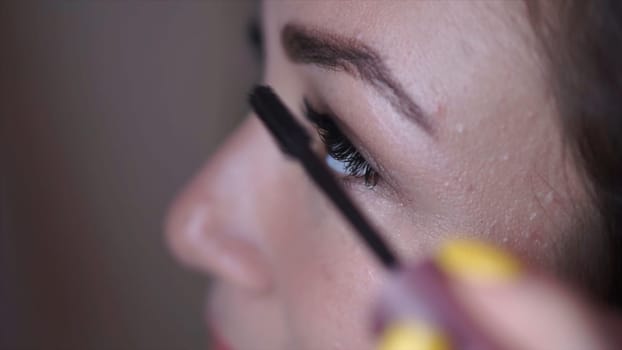 Makeup. Clip. Perfect Make-up Applying closeup. Eyeliner. Eyeline brush for Make up. Beauty Girl with Perfect Skin. Eyelashes. Makeover.