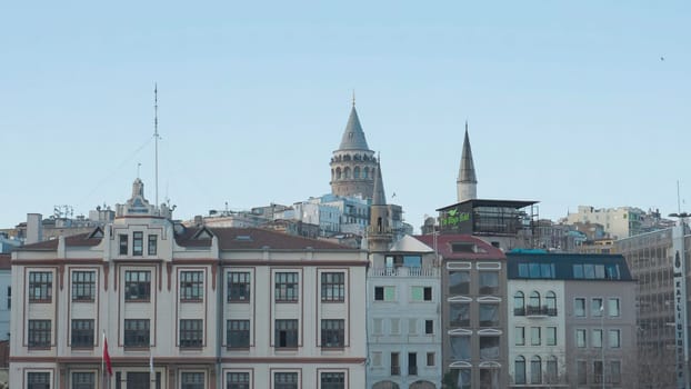 Galata Tower on background of city. Action. Ancient tower towers over center of Istanbul. Galata Tower is popular tourist attraction in Istanbul.