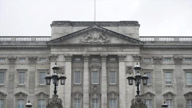 Close-up view of the Buckingham Palace exterior in rainy and gloomy autumn day. British landmarks