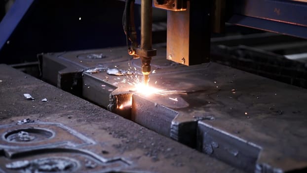 Laser plasma cutting of metal . Clip . Colorful production process at a metallurgical factory .