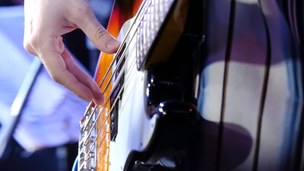 Masterful, masterly game on an electroguitar. Man plays a close up of a hand on an electroguitar.