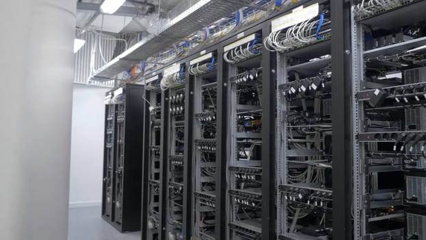 Row of bitcoin miners set up on the wired shelfs. Device for mining crypto currency. Mining cryptocurrency. Bitcoin farm. Machines for mining cryptocurrency, bitcoin. Electronic device at day 4K