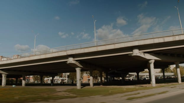 The road removed from the car. Stock footage. Streetscape with a large bridge and parks with large high-rise buildings. High quality 4k footage