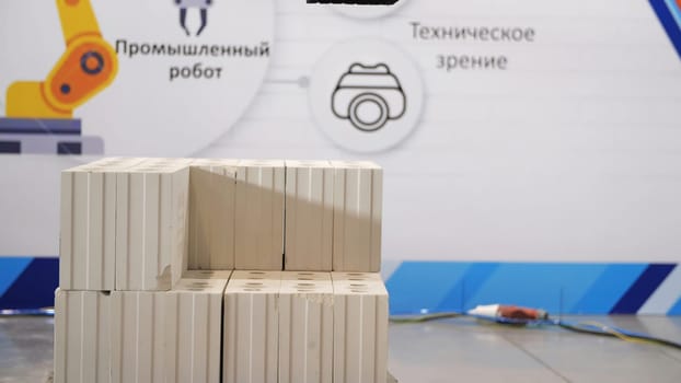 Automatics bricklayer robot exhibit showing its opportunities. Concept of robotic technologies in construction industry, building a wall the help of automated robot.