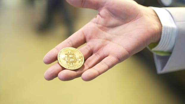 Businessman hold golden Bit coin Ticker Symbol BTC, finance money bitcoin concept. Stock. Bitcoin BTC the new virtual money.