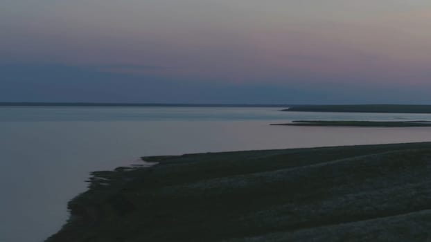 Aerial view of beautiful emerald green water lake and summer landscape sunset. Sunset on the lake.