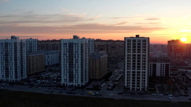 Sunset over typical panel block apartment buildings. Stock footage. Aerial view of beautiful sunset above the sleeping city area