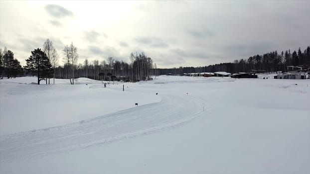 Ski race on track in winter. Footage. Top view of competing professional skiers in colorful costumes riding on track. Winter cross-country skiing competitions.