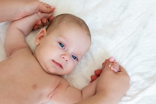 Father gently provides therapeutic touch to his peaceful infant promoting relaxation and comfort