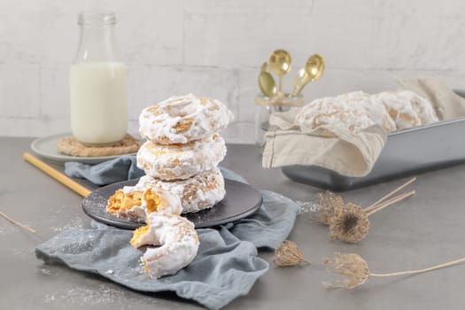 Sweet portuguese donuts with white glaze. Donuts baked at home. Simple and tasty dessert.