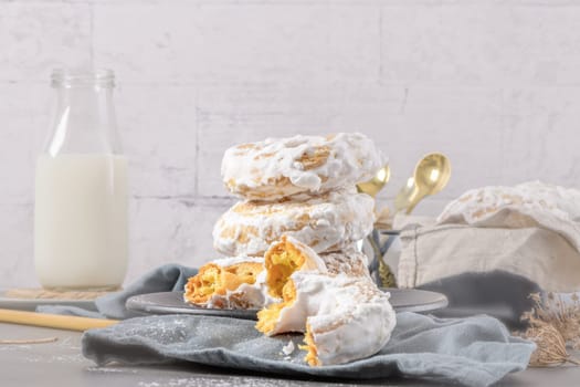 Sweet portuguese donuts with white glaze. Donuts baked at home. Simple and tasty dessert.