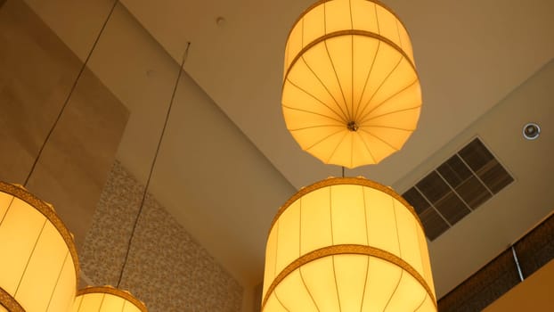 Paper lanterns hanging from the ceiling. Chinese paper lantern hanging from a ceiling. Yellow Chinese paper lantern hang on a ceil 4K