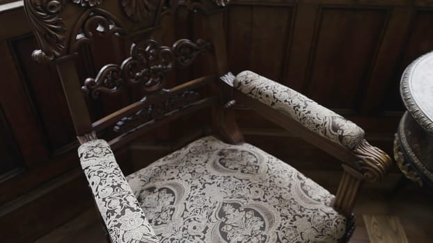 Old furniture in country estate. Action. Beautiful old furniture in museum house. Old armchairs with table in aristocratic house.