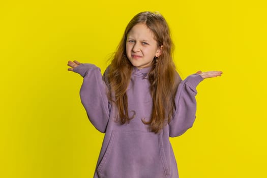 What. Why. Young redhead school girl raising hands in indignant expression, asking why, what reason of failure, demonstrating disbelief irritation by troubles. Preteen child kid on yellow background