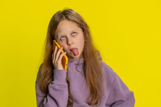 Portrait of disinterested preteen child girl kid having annoyed boring talk on smartphone. Little children tired sleepy freelancer talking on mobile phone with friend, making online conversation