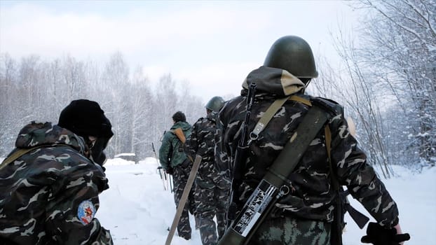 Group of special forces weapons in cold forest. Clip. Soldiers on exercises in the forest in the winter. Winter warfare and military concept.