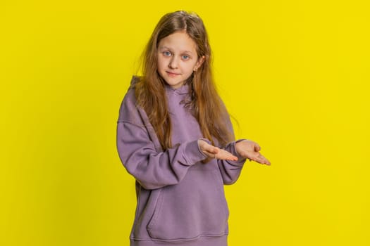 Child girl kid raising hands asking what why reason of failure demonstrating disbelief irritation by troubles. Ridicules people who complicate simple tasks for no reason. Children on yellow background