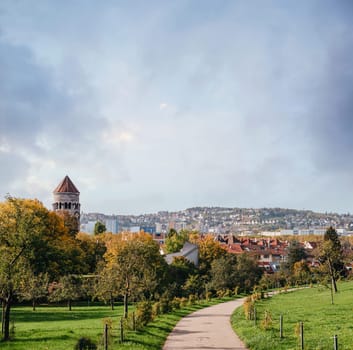 Germany, Stuttgart panorama view. Beautiful houses in autumn, Sky and nature landscape. Vineyards in Stuttgart - colorful wine growing region in the south of Germany with view over Neckar Valley. Germany, Stuttgart city panorama view above vineyards, industry, houses, streets, stadium and highway at sunset in warm orange light.