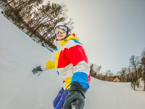 A daring man conquers snowy slopes with style, showcasing skill and thrill as he maneuvers on a snowboard, capturing the essence of winter adventure.