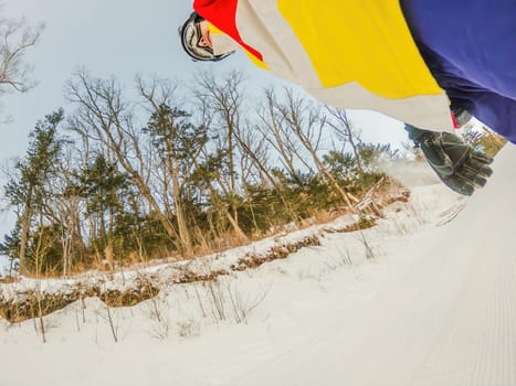 A daring man conquers snowy slopes with style, showcasing skill and thrill as he maneuvers on a snowboard, capturing the essence of winter adventure.