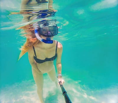 In an ethereal underwater scene, a pregnant woman gracefully floats, embodying the beauty of maternity beneath the tranquil surface of the sea.