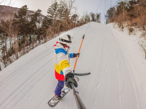 A daring man conquers snowy slopes with style, showcasing skill and thrill as he maneuvers on a snowboard, capturing the essence of winter adventure.