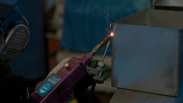 Steel welding, technician working on metal with welding machine in factory while wearing safety equipment. Creative. Construction maintenance service by manual skill labor concept