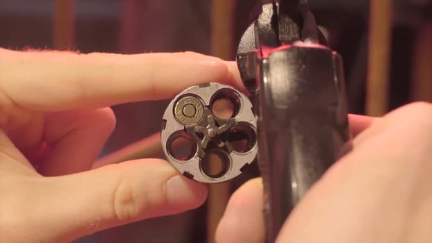Male hand reload a revolver. Magnum gun without bullets , Magnum revolver and empty bullet, Magnum. lead round nose. 45 auto rim revolver rounds HD