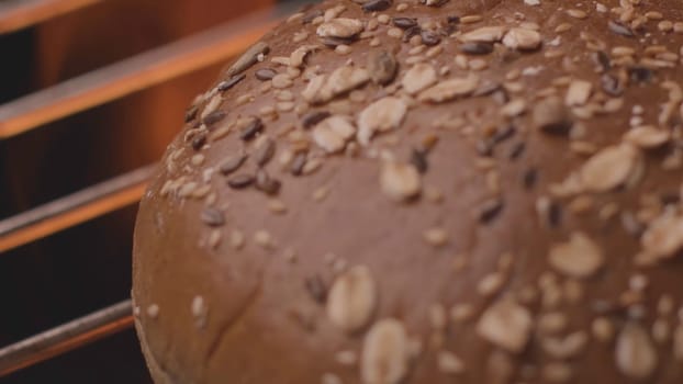 Burger bun being fried over fire. Stock footage. Close-up of round grain bun on grill. Bun for Burger to be fried on fire grill. Delicious bun for Burger on grill.