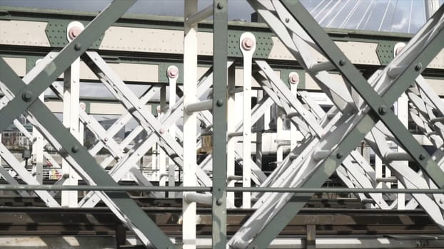 Close-up view of the white wagon going rapidly on the bridge against the blue sky. Urban rail transport