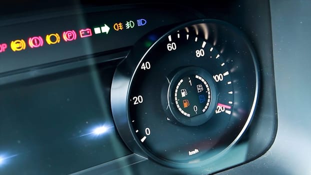 Car tachometer detail with increasing rpm value. Scene. Close up of modern panel board with burning indicators
