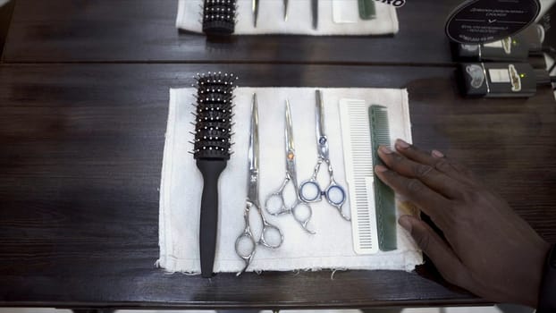 Close-up of barber set. Close-up of hands of hairdresser preparing professional set of hairdressing tools for cutting. Concept of hairdressing tools.