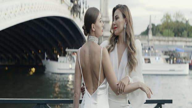 Beautiful models in open dresses. Action. Cute women in short dresses pose against the backdrop of tourist spots in good sunny weather. High quality 4k footage