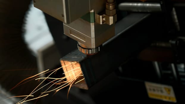 Machine for laser cutting of metal makes the cutting of a metal detail. Creative. Modern technology of metal cutting, bright flashes of sparks