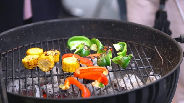 Grilling vegetables on a outdoor barbecue. Vegetables are grilled on charcoal. Vegetables are roasting on the grill.