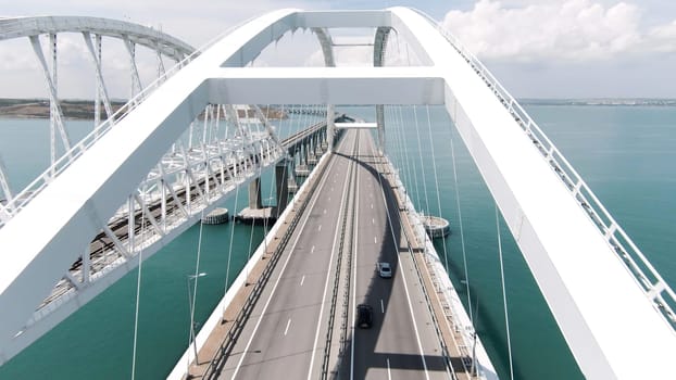 Beautiful landscape from a helicopter. Action. The view from the drone on the big white bridge on which cars move over the ocean. High quality 4k footage